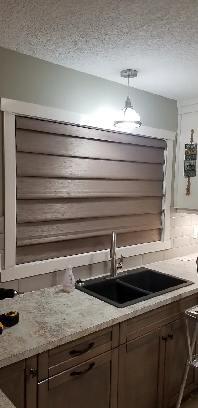 Woven shade over a kitchen sink window